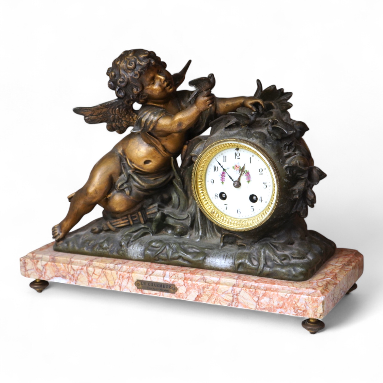 After Georges Maxim (French, 1885-1940), ‘Le Charmeur’, an early 20th century gilt spelter and rouge marble mantel clock, 39cm wide